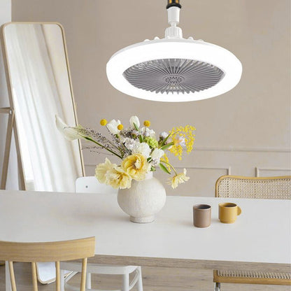 Ceiling fan above a dining table with a vase of flowers and two cups.