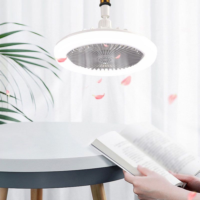 Person using a cleaning tool under a ceiling light fixture with pink leaves on a white curtain background