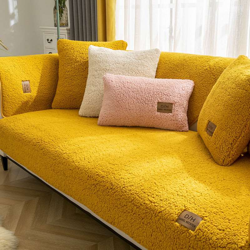 Yellow sofa with decorative pillows in a living room setting